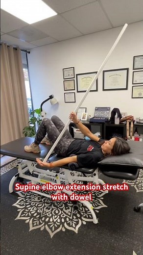 Supine elbow extension stretch with dowel