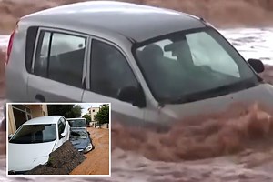 Flash floods sweep cars into sea as stranded people flee to rooftops in Crete