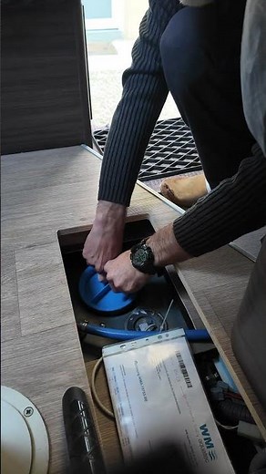 Tools for loosening a water tank access hatch on a motorhome