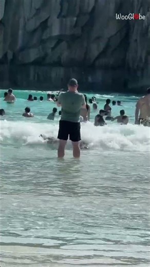 Beach Chaos: Lad Swims on Wave and Hits Man Unexpectedly || WooGlobe