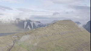 Klakkur and Suður á Nakki Mountain Peaks rising out of the Sea next to remote Klaksvík village in Northern Faroe Islands, Denmark.