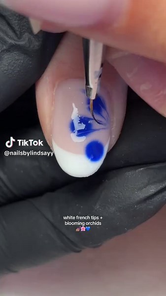 white french tips with blue blooming orchids is giving greek summer holiday vibes 🥹🇬🇷🌊🐬💅🏽🩵 please can we have this set in every. single. colour?? 👏🏼 thanks to my client for letting me do in a diff colour hehe #frenchtipnails #frenchtipnail #frenchtipnailart #frenchtipnailstutorial #frenchmanicure #frenchmani #frenchnails #frenchtip #whitefrenchtipnails #bloominggel #bloominggelnails #bloominggelnailart #bloominggelnailinspo #bloominggeltutorial #bloominggelart #bloominggelflowers #bloo