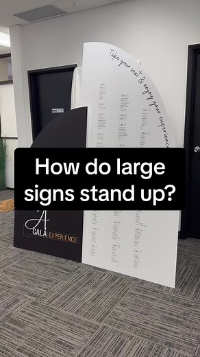 How do we make these giant signage boards stand?