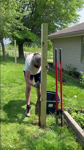 Tamping the clothes line posts. 4x4 treated posts NO CONCRETE!!