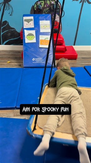 Halloween therapy in action! Lying prone on the platform swing while tossing bean bags at spooky targets helps kids build core strength, hand-eye coordination, motor planning, and vestibular processing — all while having a ghoulishly good time! 🌟💪 #PediatricOT #OTForKids #HalloweenFun #CoreStrength #HandEyeCoordination #MotorPlanning #VestibularProcessing #PlayBasedTherapy #OccupationalTherapy #ChildDevelopment #SpookySkills | Sensational Development Occupational Therapy