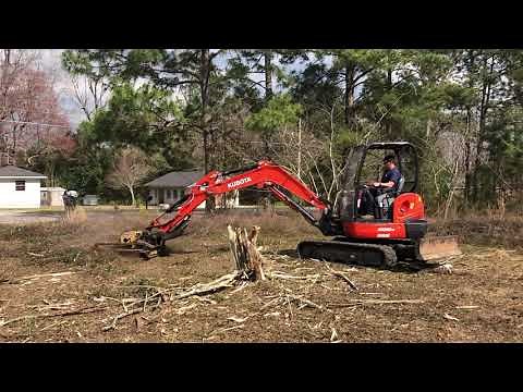 Kubota KX040-4 mini ex mowing overgrown lot with brush cutter