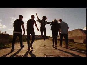 happy young people laughing and raising hands