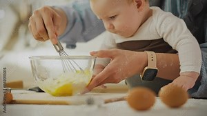 Food. Caring parent using egg beater kitchen utensil to bake pancakes in home kitchen. A woman of European appearance beats eggs with a whisk, applies current educational methods, folds