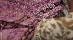 Batik, Close Up hand and canting, making Batik Tulis Indonesia. Canting is tool for drawing the texture on the fabric.