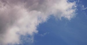Download Time lapse of soft dynamic cumulus clouds changing shape from left to right in 4K for free