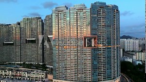 High-rise residential buildings in Cyberport (Bel-Air). Sunset time with modern housing blocks of Hong Kong. Aerial approaching shot.