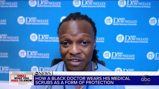 African American doctor wears scrubs as form of protection