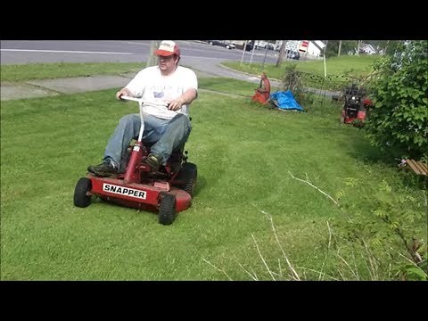 The 33 inch Snapper rear engine rider classic with 14hp briggs cutting my grass lawn supper happy fu