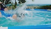 Girls jumping into swimming pool. Slow Motion.