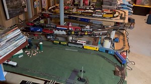 It’s just a bunch of ovals, but I like it. Each freight engine has several different consists it can pull, and the rotation keeps running them interesting and a little different every day! The Amtrak in the middle brings back good memories of yearly trips with my father at the end of each school year growing up. Sorry the bottom oval is obscured by a pile of “Classic Toy Trains” issues 🙂 Enjoy! | George Berry