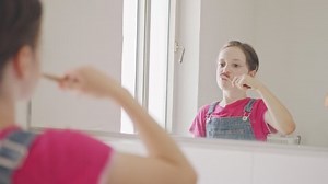 clip-1055197178-little-girl-brushing-her-teeth-bathroom-morning