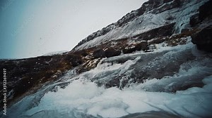 Water flowing at top of dynjandi waterfall in Iceland in, streaming rapidly in slow motion