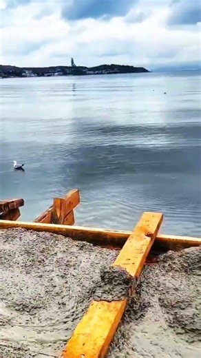 Hose pours concrete, foundation forms by water