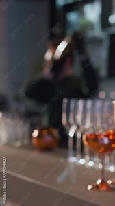 Bartender preparing cocktail drink in cocktail shaker. The process of making a cocktail at a bar in a restaurant. Bartender mixes the ingredients of an cocktail by shaking a shaker. Blurry video.