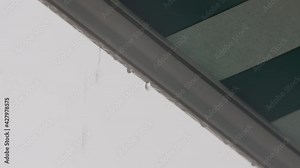 Raindrops dripping from edge of awning
