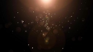 Golden particles falling down bokeh abstract background with shining gold Dust Particles Flare star on Black Background in Slow Motion. Futuristic glittering fly movement flickering loop in space.