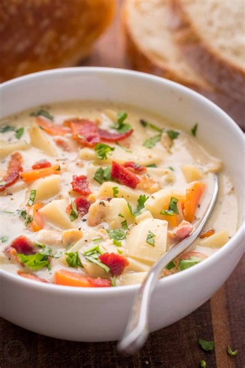 My New England-style clam chowder recipe is loaded with tender clams, silky potatoes, and crunchy bacon. Recipe: https://natashaskitchen.com/clam-chowder-recipe-video/ | NatashasKitchen.com