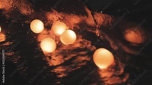 Production of metal balls in a factory, movement of hot balls, rolling metal balls, slow motion