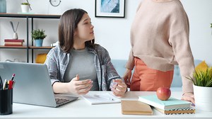 Teenage Girl Doing Homework with Mother's Help | Vídeo stock Premium