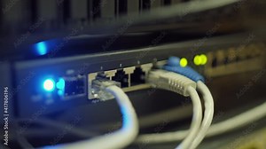 Close up of network panel of mainframe with wires and LEDs in server room
