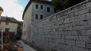 DOLLY SHOT SLOW MOTION - The Ile palace (former prison) home to the Annecy History museum, Thiou Canal without water and the Quai des Vieilles Prisons street, Annecy, France.