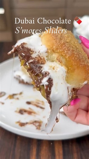Dubai Chocolate S’mores Sliders. Soft rolls layered with pistachio cream, flaky phyllo, melted chocolate, and gooey marshmallow, finished with buttery cinnamon sugar and graham cracker crumbs. These sliders are warm, gooey, and honestly perfect for summer nights or when you want something extra. 🍫Comment “SLIDERS” below & I’ll send you the printable recipe. #recipe below Ingredients • 9-10 mini slider rolls • 8 tbsp unsalted butter, room temperature • 1 tbsp sugar • ½ tsp cinnamon • 1 cup pista