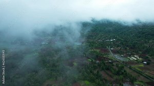 4K aerial view of Flying through rain clouds above green mountain covered by jungle and small villages at Saputara, Dang, India. Wonderful rainy day. Natural landscape