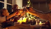 Family toasting wine at christmas dinner. Family enjoying christmas...