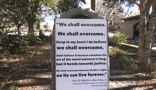 ‘We Shall Overcome’ sign covers confederate monument during MLK day parade