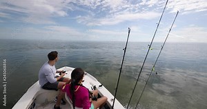 Fishing from boat - people going fishing with fishing rod on open water. Man and woman going shark fishing in the Keys, Florida, USA. Stock Video