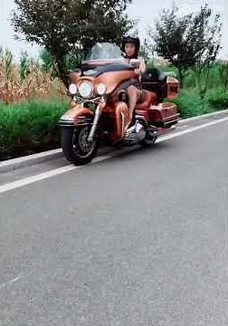 Girl in skirt takes off on harley davidson motorcycle