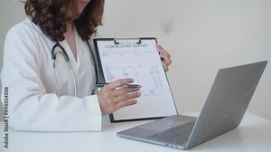 The doctor hand points report and explains Telemedicine the health examination results to the patient, the medical checkup concept.