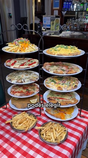 El Progreso Restaurante on Instagram: "PARA LOS FANÁTICO DE LA MILANESA! 🍽️🔥 En El Progreso tenemos la promo más épica: nuestra Torre de 5 Milanesas Gigantes 🤯. Ideal para compartir entre 5 (¡hasta 6!) personas por solo $15.000 cada uno 😎. ➕Qué incluye? 👉 5 milanesas XL con guarnición de papas fritas 🍟 👉 Podés reemplazar una de ellas por papas con cheddar y bacon 🧀🥓 👉 Elegí los sabores que más te gusten: Napolitana, Fugazzetta, Suiza, Americana, Con Fideos y muchos más 🤤 💥 Precio act