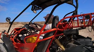 Blonde woman riding buggy car. Female tourist driving on sand buggy. Concentrated woman driver ride in desert buggy. Safari transport. Summer entertainment. Woman drive on sand vehicle