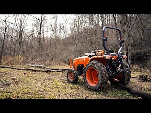 Skidding logs with a 25hp compact tractor.