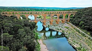 Aerial view of the aqueduct bridge with arched tiers in France. Drone view of Pont du Gard the highest Roman aqueduct bridge in the world.