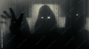 Silhouettes of three people in hoods with glowing eyes behind a transparent curtain, raising their heads and pulling out their hands. Concept of demons, paranormality, ghosts. 4k video 60 fps.
