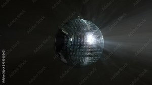 Disco Ball with Reflected Moving Rays Rotating. Mirror disco ball in white light. Isolated disco ball on black background. Close-up. Mirror ball spinning indoors. Performance. The reflection of lights