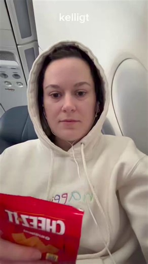 American shows an unopened Cheez-It bag she was given on a Delta Airlines flight.She opens it on camera so you can see just how much corporations can cut back on giving us.