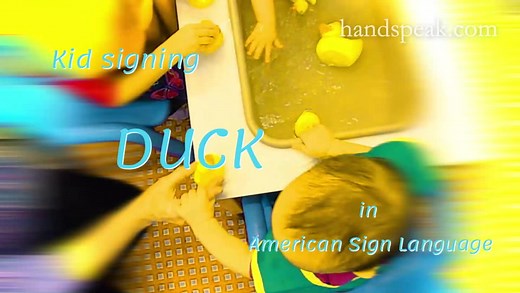 Toddler signing DUCK in ASL.