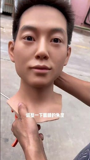 The wax figure's bright eyes don't blink while watching.