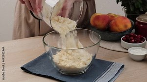 The process of making a shortcrust pastry pie. Kneading the dough and making buttercream. Woman prepares a sweet shortbread pie with peaches and cranberries.Video recipe - step by step cooking