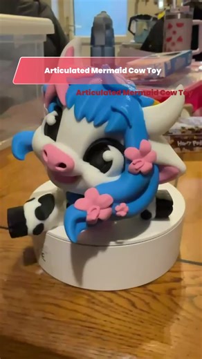 🐄🧜‍♀️ Articulated Mermaid Cow – Moo-maid Magic Edition 🐄🧜‍♀️ Behold… the Mermaid Cow you never knew you needed, but absolutely cannot live without. This adorable mash-up features a white cow with black spots, flowing blue hair, pink seashell details, and—because of course—a mermaid tail. Logic left the chat, cuteness took over. Why She’s Udder-ly Amazing ✨ Fully Articulated Fun Designed with movable joints so your Moo-maid can strike her best “just surfaced from the sea” pose or lounge drama