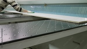 Chipboard production workshop, production of chipboard, veneer, plywood, wood panels. Wood processing. Woodworking industry concept. Automatic cutting of chipboard in the furniture industry.