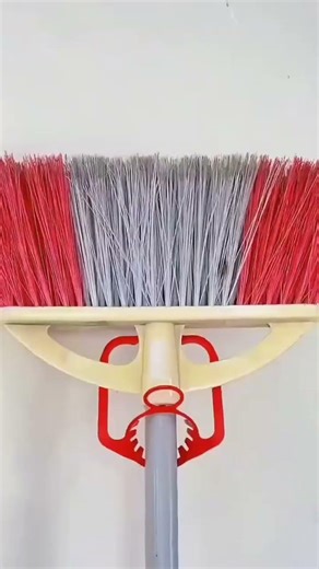 Creative use of a gallon handle to hang a broom. Simple idea, neat storage, and very useful.
